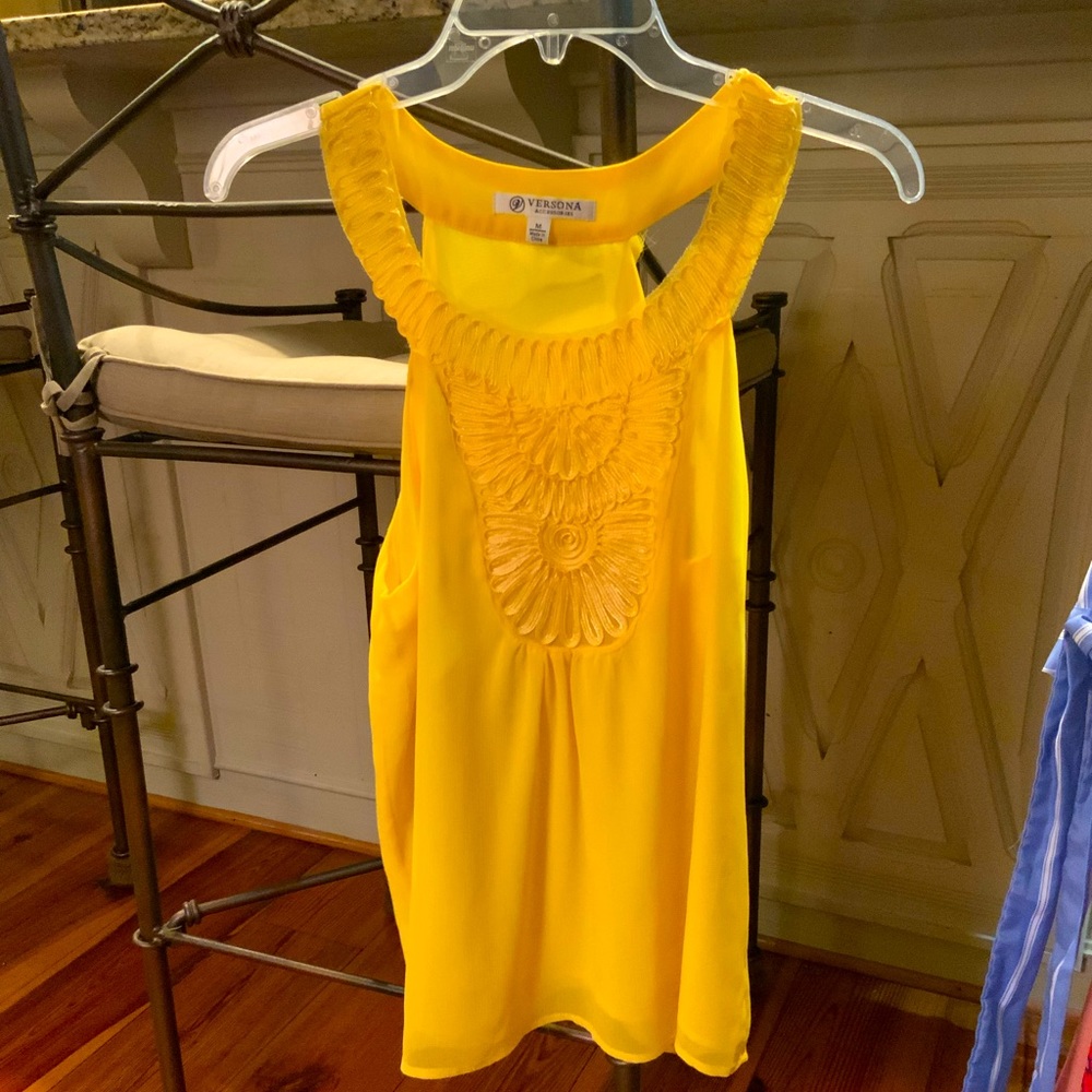 Sleeve-less yellow women’s blouse.